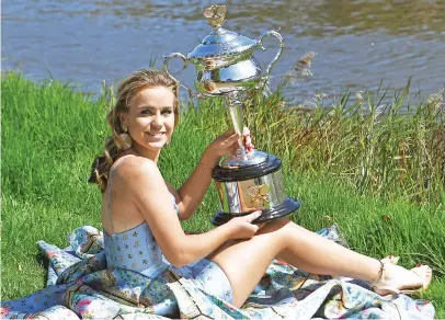  ?? Picture: AFP ?? CHAMPION. Sofia Kenin of the US poses with the Australian Open trophy on a bank of the Yarra river in Melbourne following her victory over Spain’s Garbine Muguruza in the women’s final on Saturday.