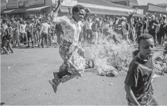  ??  ?? Hundreds of angry opposition supporters protesting in the streets of Harare on Wednesday were met by riot police firing tear gas as Zimbabwe awaited the results of Monday’s presidenti­al election.