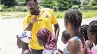  ??  ?? Joshua Bailey, outreach officer at the Montego Bay Marine Park Trust, conducts swimming lessons with children who attended the summer class organised by the trust.