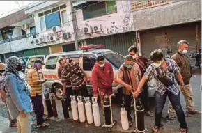  ?? AFP PIC ?? Residents queuing to refill oxygen tanks in Surabaya recently after the government ordered the nation’s oxygen supplies to be directed to hospitals overflowin­g with Covid-19 patients.