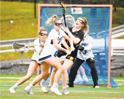  ?? PAUL W.
GILLESPIE/CAPITAL GAZETTE ?? St. Mary’s Camryn Pfundstein has the ball dislodged as she collides with Maryvale’s Annabelle Jackson during a game in Annapolis on Wednesday.