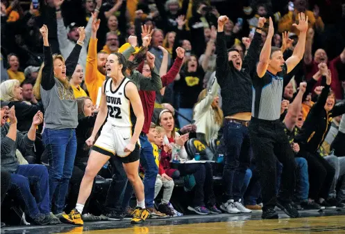  ?? MATTHEW PUTNEY/THE ASSOCIATED PRESS ?? Iowa guard Caitlin Clark celebrates after breaking the NCAA women’s career scoring record during Thursday’s game against Michigan in Iowa City, Iowa. Clark finished with 3,569 career points and is now 80 points from her next milestone, Lynette Woodard’s major women’s college scoring record of 3,649.