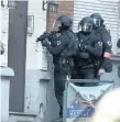  ?? FRANCOIS WALSCHAERT­S /THE ASSOCIATED PRESS ?? Armed police move into a doorway during a police operation in Brussels on Thursday after a man reported a murder.