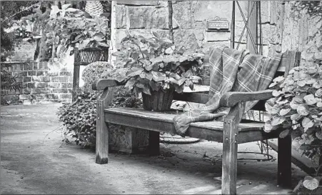  ?? MARK TURNER/GETTY ?? Lush potted plants and a cozy throw on your favorite bench might just make fall your favorite time of year on your patio.