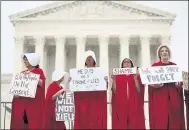  ?? PABLO MARTINEZ MONSIVAIS — THE ASSOCIATED PRESS ?? Activists protest in front of the Supreme Court on Tuesday. A Supreme Court with a new conservati­ve majority took the bench as Brett Kavanaugh joined his new colleagues to hear his first arguments as a justice.