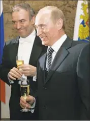  ?? Dmitry Lovetsky Associated Press ?? RUSSIAN conductor Valery Gergiev, left, and President Vladimir Putin at the Mariinsky Theatre in ’08.