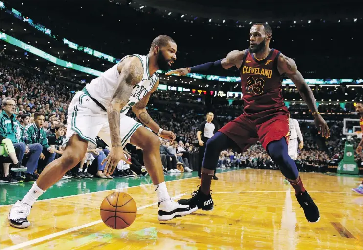  ?? — THE ASSOCIATED PRESS ?? Celtics forward Marcus Morris, left, goes up against Cleveland Cavaliers superstar LeBron James during Sunday’s Eastern Conference Finals game in Boston.