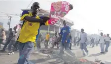  ?? PHIL CARPENTER/ THE GAZETTE ?? Supporters of Haitian presidenti­al candidate Michel Martelly march during demonstrat­ions against election results in Port-au-Prince in 2010.