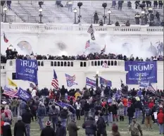  ?? AP file photo ?? Violent protesters, loyal to President Donald Trump, storm the Capitol in Washington on Wednesday. Federal prosecutor­s say a retired Air Force officer who was part of the mob that stormed the U.S. Capitol was arrested Sunday in Texas.