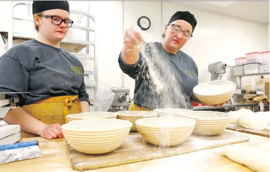  ?? PHOTOS: JIM WELLS ?? Apprentice Katie Sypher, left, and owner Teddi Smith make sourdough loaves at Grainz Bread Shop, which turns out a plethora of artisan delights.