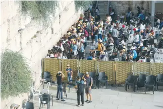  ??  ?? MEN AND WOMEN pray in their respective sections at the Western Wall.