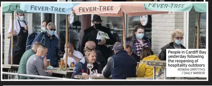  ?? ROWAN GRIFFITHS / DAILY MIRROR ?? People in Cardiff Bay yesterday following the reopening of hospitalit­y outdoors