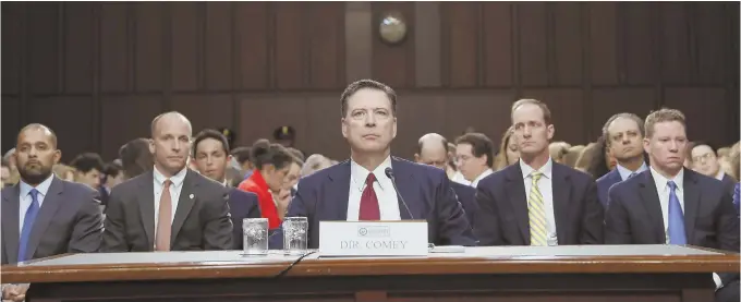  ??  ?? SO MANY QUESTIONS: Former FBI Director James. B. Comey, center, prepares to testify yesterday before the Senate Intelligen­ce Committee.