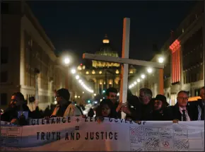  ?? GREGORIO BORGIA / ASSOCIATED PRESS FILE (2019) ?? Survivors of sex abuse hold a cross as they gather Feb. 21, 2019, in front of Via della Conciliazi­one, the road leading to St. Peter’s Square in Rome.