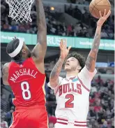  ?? NAM Y. HUH/AP ?? Lonzo Ball shoots against Pelicans forward Naji Marshall on Friday.