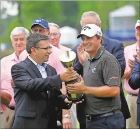  ??  ?? Gerald Herbert / The Associated PressBrian Stuard receives the tournament trophy from Rohit Verma, Regional Executive for Zurich North America, after winning the rain-delayed Zurich Classic at TPC Louisiana.