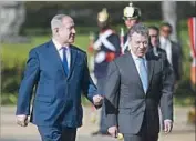  ?? Raul Arboleda AFP/Getty Images ?? IN COLOMBIA, President Juan Manuel Santos, right, welcomes Israeli Premier Benjamin Netanyahu.