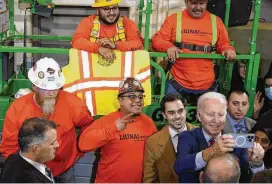  ?? PATRICK SEMANSKY / ASSOCIATED PRESS ?? President Joe Biden takes a photo with workers after delivering remarks on his economic agenda at LIUNA Training Center, Wednesday in DeForest, Wis.