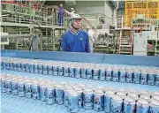  ?? [AP PHOTO] ?? Asahi Breweries plant manager Shinichi Uno watches the production line. The human job is to make sure the machines do the work right, and to check on the quality the sensors are monitoring.