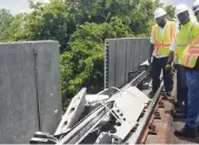  ?? Miami ?? A Miami-Dade repair crew surveys the damage of a Metrorail acoustical barrier that failed in July 2018.