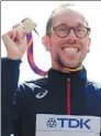  ?? TOBY MELVILLE / REUTERS ?? Yohann Diniz of France poses with his medal after winning the men's 50km walk in London on Sunday.