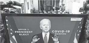 ?? JOSHUA ROBERTS/ GETTY IMAGES ?? President- elect Joe Biden is shown speaking about the coronaviru­s pandemic on a monitor in the briefing room of the White House on Monday.