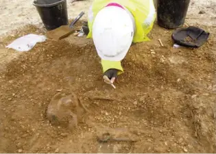  ??  ?? Above: Excavation of a female at Burnby Lane in Barrow 2, buried with rare jewellery, below: a copper-alloy bracelet on each wrist, one with coral inlay, and a brooch with a wide
h- shaped frame decorated with coral