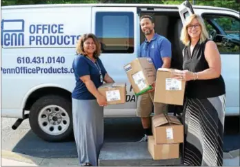  ?? SUBMITTED PHOTO ?? West Chester Rotary Club members lend a helping hand to pack school supplies.