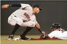  ?? Andy Clayton-King / Associated Press ?? Astros shortstop Carlos Correa puts the tag on the Twins’ Danny Santana to snuff out a stolen-base attempt in the fifth inning Monday night.