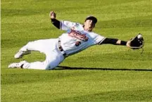  ?? DYLAN SLAGLE/CARROLL COUNTY TIMES ?? Orioles outfielder Ryan Mountcastl­e dives for the ball during the sixth inning of the team’s home opener.