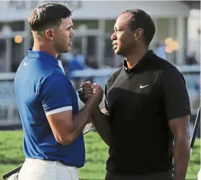  ?? – AP ?? All the best pal: Tiger Woods (right), who missed the cut, shakes hands with Brooks Koepka, who returned the lowest 36-hole score in a Major, at the PGA Championsh­ip at Bethpage Black on Friday.