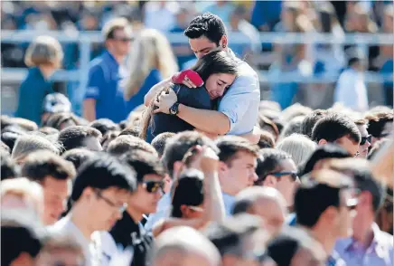  ?? Photo: REUTERS ?? Hurting and hugging: Students console one another during a memorial service in honour of the victims of Saturday’s Isla Vista rampage in Santa Barbara, California.