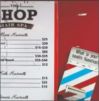  ??  ?? A box encouragin­g barber shop patrons to submit health questions is displayed at The Shop in Hyattsvill­e.