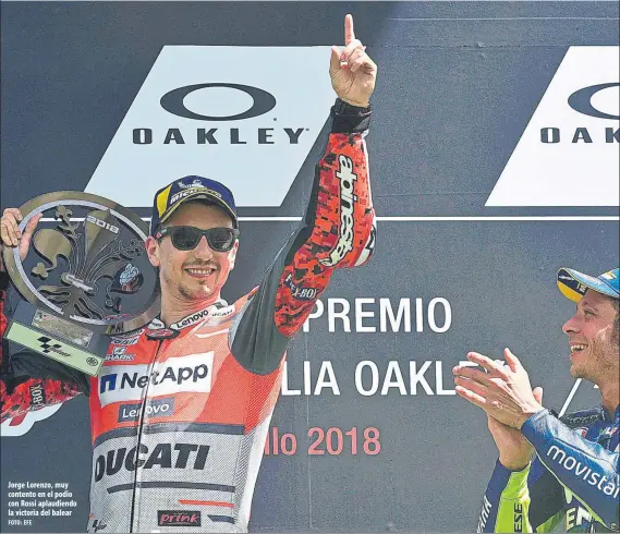  ?? FOTO: EFE ?? Jorge Lorenzo, muy contento en el podio con Rossi aplaudiend­o la victoria del balear