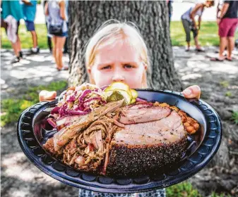  ?? Chronicle file ?? Don’t overload your plate with more than you can eat at the backyard barbecue.