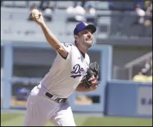  ?? KEVIN REECE Special to the Valley Press ?? The Dodgers’ Max Scherzer throws against the Padres on Sunday. He pitched his 3,000th career strikeout against Padres first baseman Eric Hosmer in the fifth inning and was perfect through seven innings in the Dodgers’ 8-0 victory.