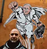  ?? Gregorio Borgia/Associated Press ?? Italian artist Mauro Pallotta poses in front of his graffiti of Superman Pope Francis at the Borgo Pio district near St. Peter’s Square in 2014.