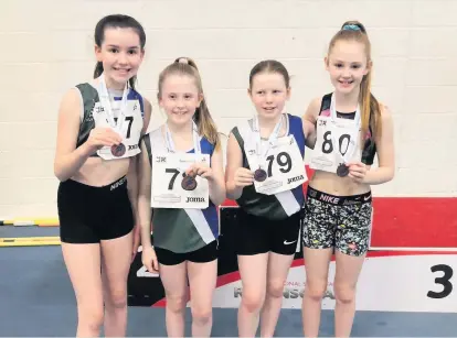  ??  ?? Medal winners Hamilton and District’s Abbie Dick, Eva Gray, Rose Scott and Layla Reddiex with their prizes