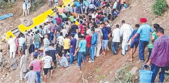  ?? Picture: TIFFANY BAKKER ?? A crowd gathers at the site of the bus crash that killed at least 24 children in the northern Indian state of Himachal Pradesh.