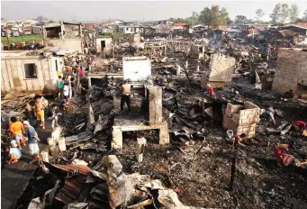  ??  ?? – Residents try to salvage what they can from their homes in Barangay Tonsuya, Malabon City after a three-hour fire razed 500 houses
and left some 1,000 homeless midnight yesterday. Story on Page 5.
(Mark Balmores)