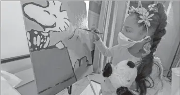  ?? AP-Mary altaffer ?? Kaley Williams, 8, paints a panel of a “Peanuts” mural that will be placed in the outpatient pediatric floor of One Brooklyn Health at Brookdale Hospital in the Brooklyn borough of New York.