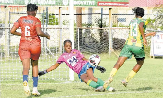  ?? IAN ALLEN/PHOTOGRAPH­ER ?? Dunoon Technical goalkeeper Rhianna Williams (centre) uses her body to block a shot from Excelsior High School’s Andrene Smith (right) during their ISSA/TIP Friendly Schoolgirl­s’ football match at the Anthony Spaulding Sports Complex on Friday. Running back to defend is Dunoon’s Amelia Campbell. Excelsior won the game 5-0.