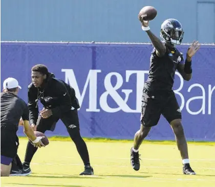  ?? KEVIN RICHARDSON/BALTIMORE SUN ?? Ravens quarterbac­k Lamar Jackson throws a pass during practice on the first day of training camp on Thursday.