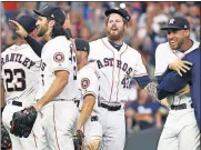  ?? [AP PHOTO/ERIC CHRISTIAN SMITH] ?? Reliever Chris Devenski, second from right, and the Astros celebrate their 9-0 win Saturday over the Mariners, with a four-pitcher combined no-hitter.