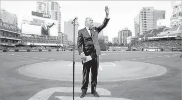  ?? Denis Poroy Getty Images ?? DICK ENBERG waves to the crowd at Petco Park during a ceremony to honor him before his last home game as the Padres’ main play-by-play announcer for television broadcasts.