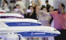  ?? — Reuters ?? Visitors look at models of Boeing aircrafts at the Aviation Expo China, in Beijing.