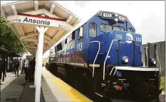  ?? Ned Gerard / Hearst Connecticu­t Media file photo ?? The Waterbury line Metro-North train pulls through the Ansonia train station in July 2018.