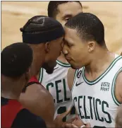  ?? MICHAEL DWYER — THE ASSOCIATED PRESS ?? Celtics forward Grant Williams, right, has words with Heat forward Jimmy Butler on Friday during Game 2.