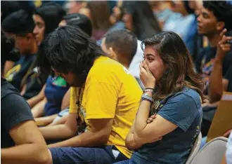  ??  ?? Senior Zaida Morales gets emotional Wednesday as she listens to the Spring Woods High School principal talk to her class at the end of their graduation rehearsal at Coleman Coliseum.