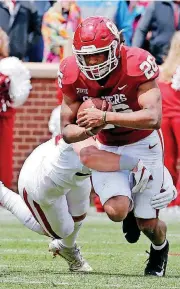 ?? [PHOTO BY STEVE SISNEY, THE OKLAHOMAN] ?? Oklahoma running back Kennedy Brooks is tackled by Levi Draper during Saturday’s spring football game in Norman.